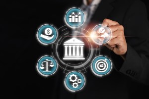 Uma mão apontando para símbolos que remetem a empresas do setor financeiro, trazendo o contexto de ranking das instituições financeiras no mercado de capitais.