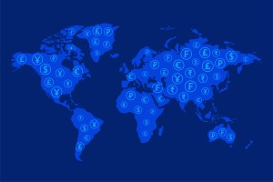 Ilustração apresenta o mapa do mundo todo em azul com o símbolo de várias moedas, trazendo o conceito de paraísos fiscais.